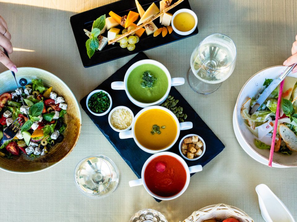 sliced bread with sliced tomato and green leaf vegetable on white ceramic plate
